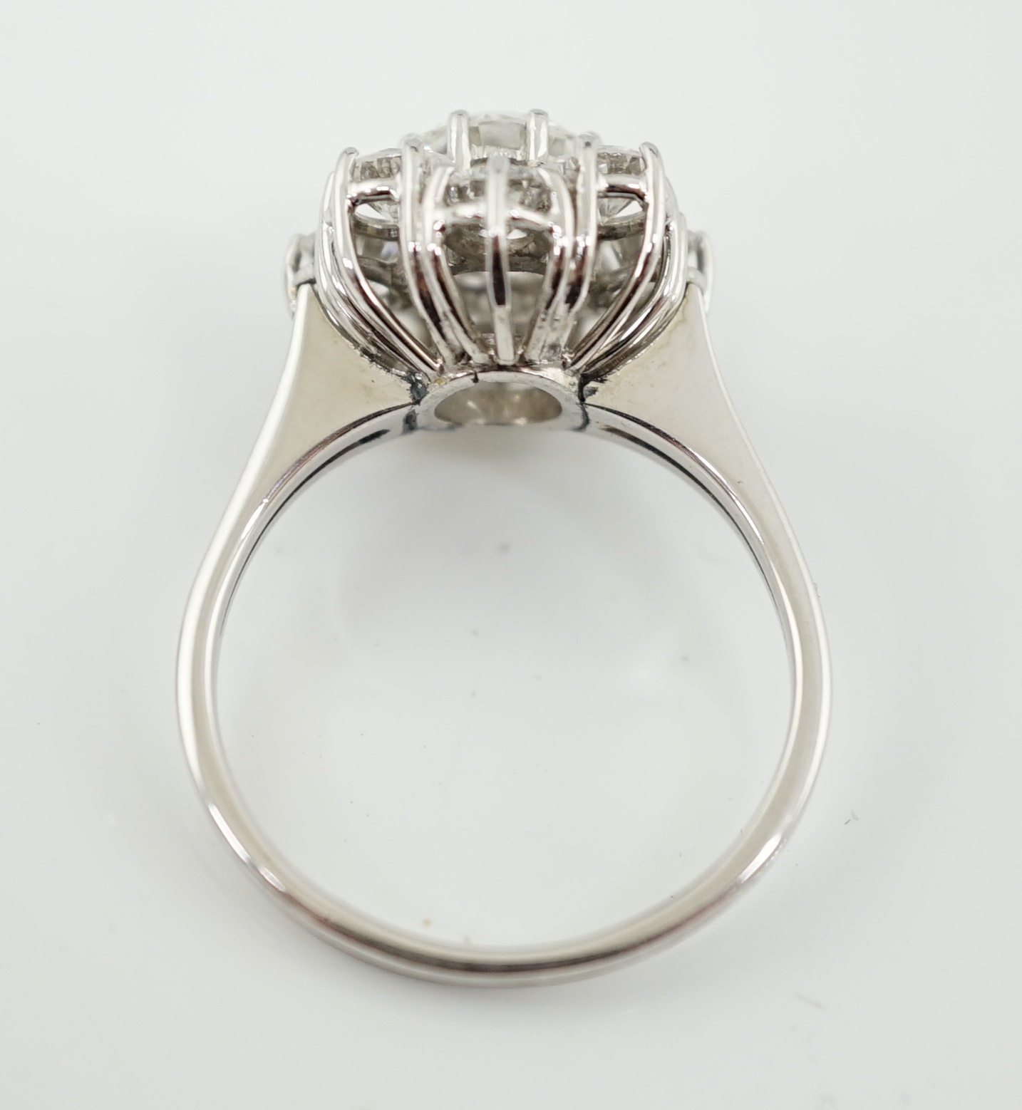 A modern 18ct white gold and round brilliant cut nine stone diamond set cluster ring